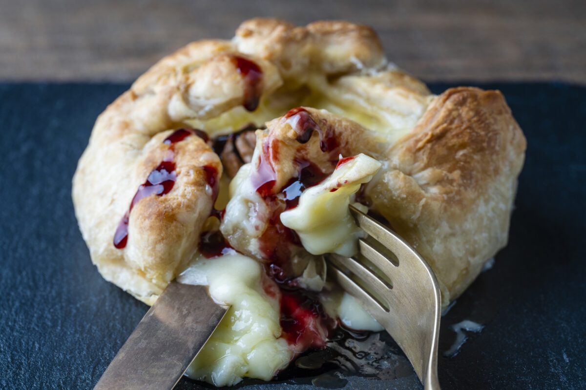 MouCo Camembert cheese baked in puff pastry topped with red berry jam