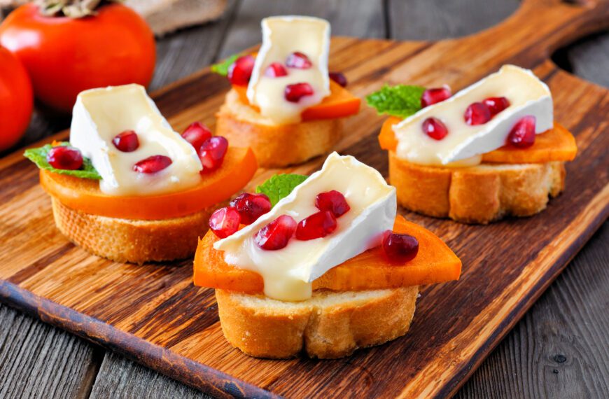 Crostini appetizers with persimmons, pomegranates and MouCo Camembert